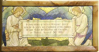 War memorial with two angels holding a scroll bearing an inscription.
